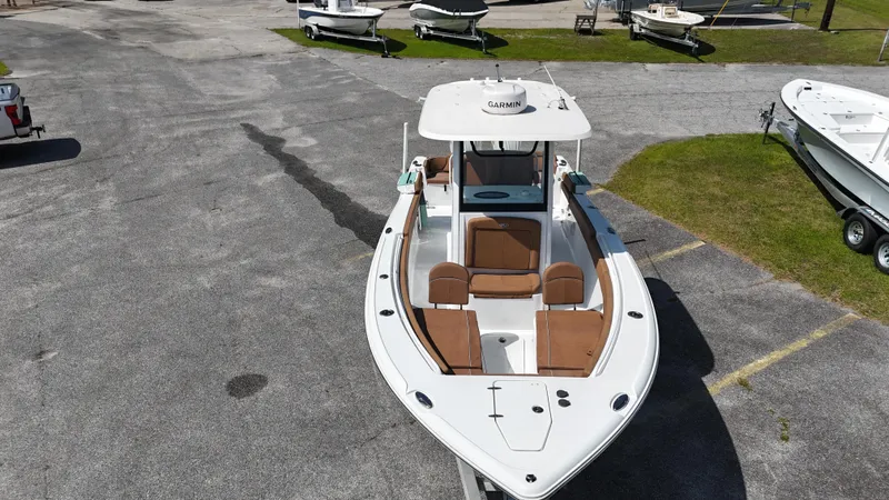 Slide: The Image of 2024 Sea Hunt Ultra 265 SE boat on display in a parking area. - 4