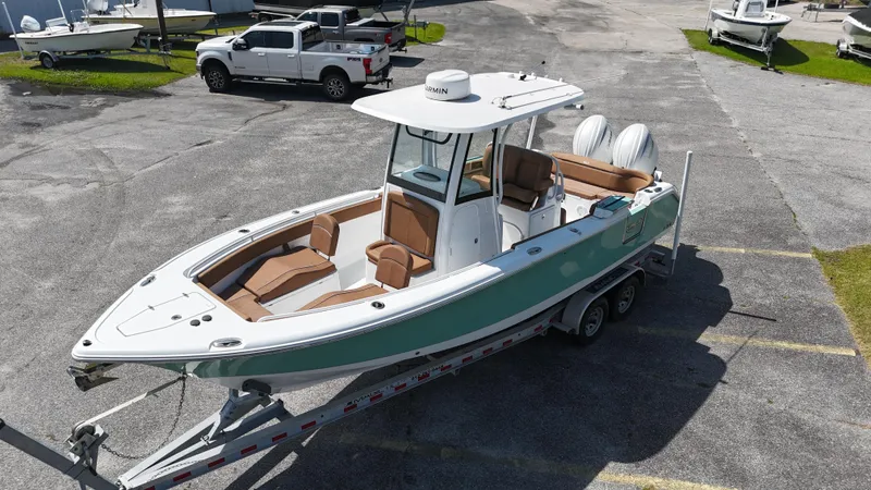 Slide: The Image of 2024 Sea Hunt Ultra 265 SE boat on trailer, parked in a lot. - 5