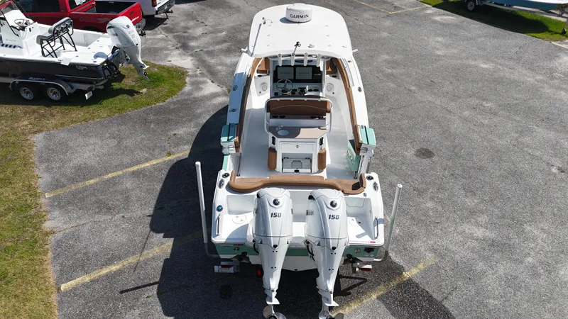 Slide: The Image of 2024 Sea Hunt Ultra 265 SE boat with dual engines, parked in a lot. - 6