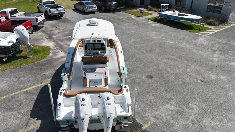 Slide: The Image of 2024 Sea Hunt Ultra 265 SE boat with dual engines in a parking lot. - 8