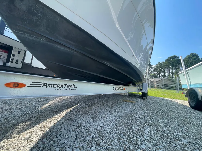 Slide: The Image of 2020 Cobia 262 Center Console boat on AmeraTrail trailer, parked on gravel. - 6