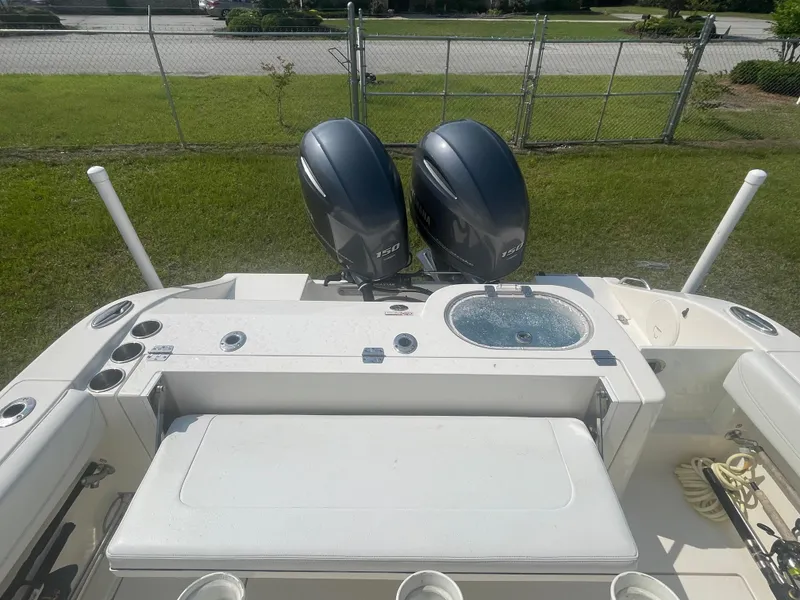 Slide: The Image of 2020 Cobia 262 Center Console boat with dual outboard engines and fishing amenities. - 7