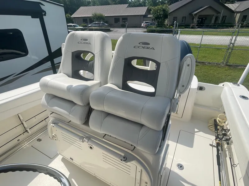 Slide: The Image of 2020 Cobia 262 Center Console boat seats, featuring plush, ergonomic design in a sunny outdoor setting. - 8