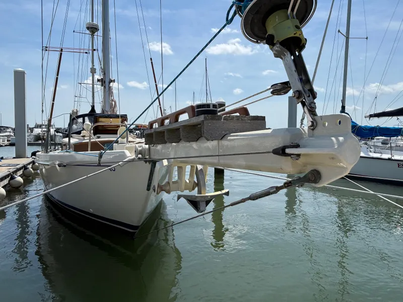 Slide: The Image of 1955 Hinckley 36 Auxiliary Yawl docked in a marina, showcasing classic design. - 2