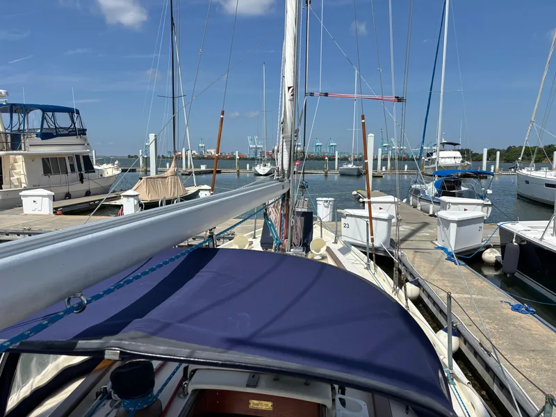 Slide: The Image of Hinckley 36 Auxiliary Yawl, 1955, docked at a marina with other boats. - 23