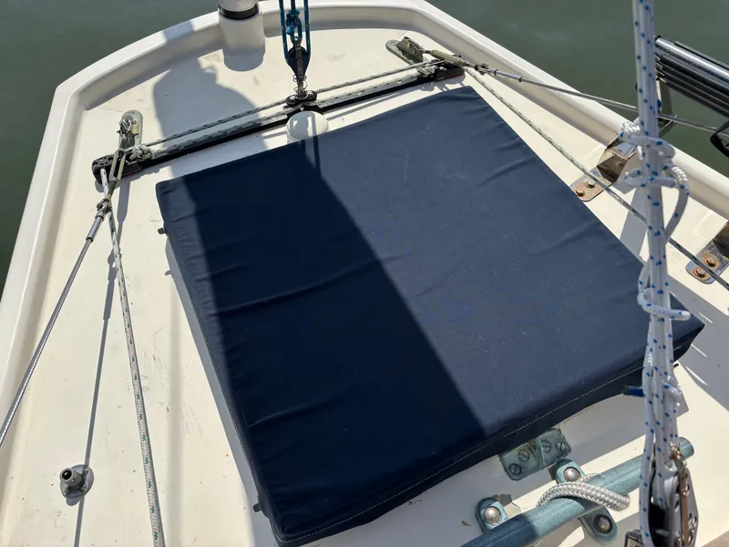 Slide: The Image of 1955 Hinckley 36 Auxiliary Yawl deck with blue cushion and rigging details. - 24