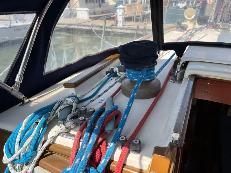 Slide: The Image of Hinckley 36 Auxiliary Yawl, 1955, deck view with ropes and winch in marina setting. - 28
