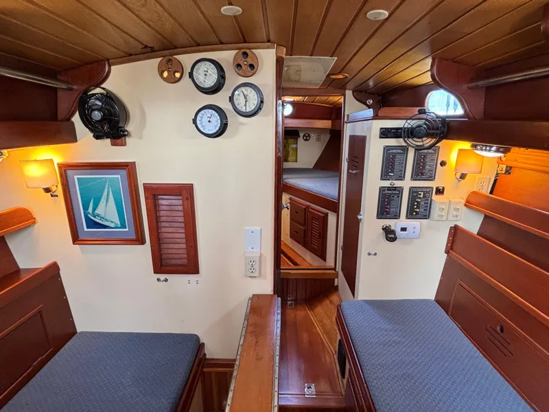 Slide: The Image of Interior of 1955 Hinckley 36 Auxiliary Yawl, featuring wood paneling and nautical instruments. - 33