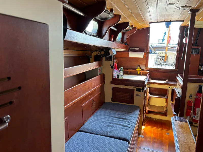 Slide: The Image of Interior of a 1955 Hinckley 36 Auxiliary Yawl, featuring wooden finishes and cozy seating. - 40