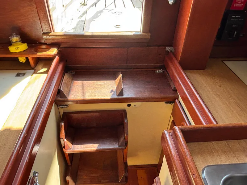 Slide: The Image of Interior of 1955 Hinckley 36 Auxiliary Yawl, featuring wooden cabinetry and natural light. - 41