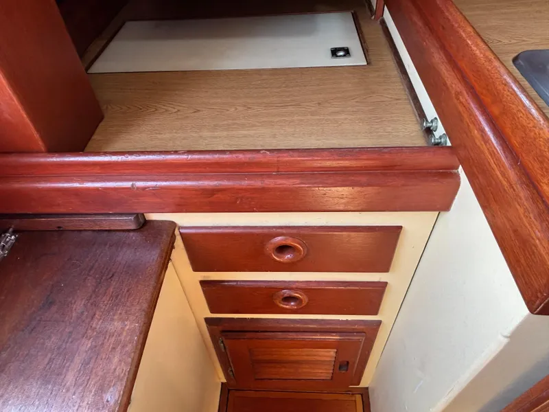Slide: The Image of Interior of 1955 Hinckley 36 Auxiliary Yawl with wooden cabinetry and drawers. - 45