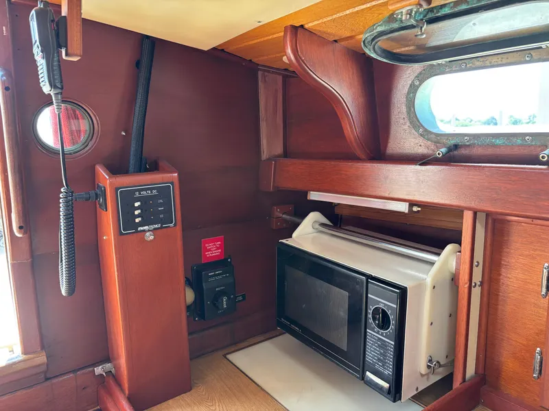 Slide: The Image of Interior of 1955 Hinckley 36 Auxiliary Yawl with microwave and control panel. - 47