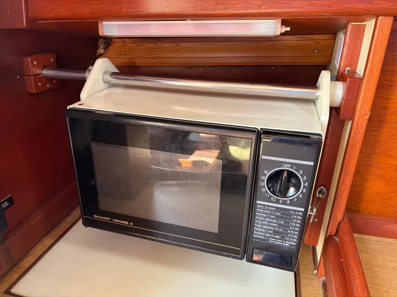 Slide: The Image of Microwave oven inside a 1955 Hinckley 36 Auxiliary Yawl's wooden interior. - 48