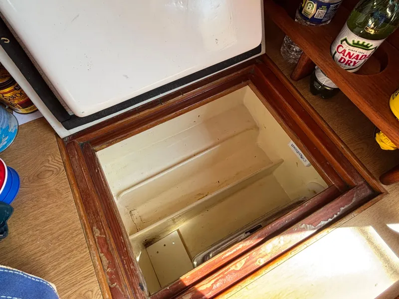 Slide: The Image of Open hatch on 1955 Hinckley 36 Auxiliary Yawl, revealing storage space. - 49