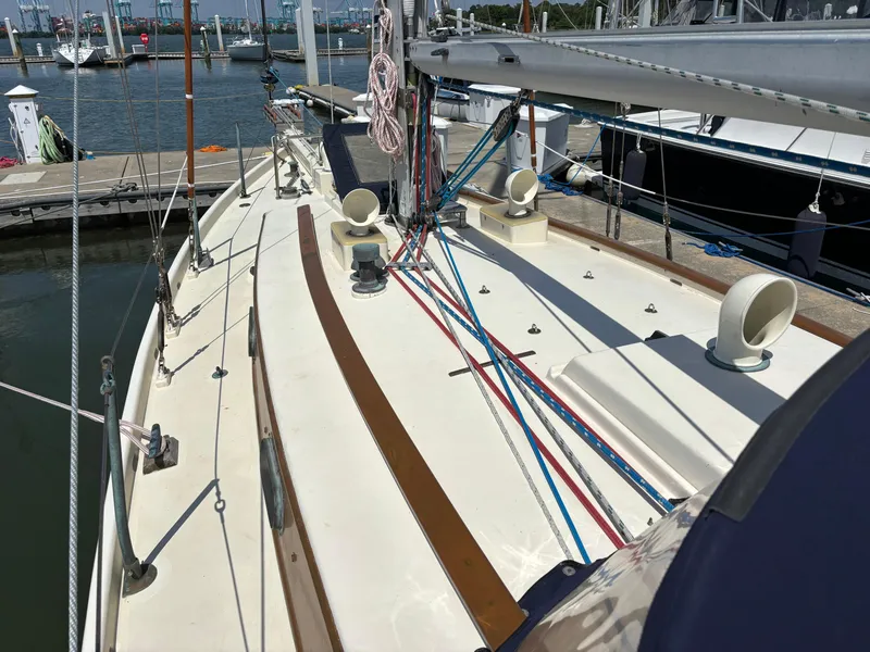 Slide: The Image of 1955 Hinckley 36 Auxiliary Yawl sailboat deck with rigging at marina. - 11
