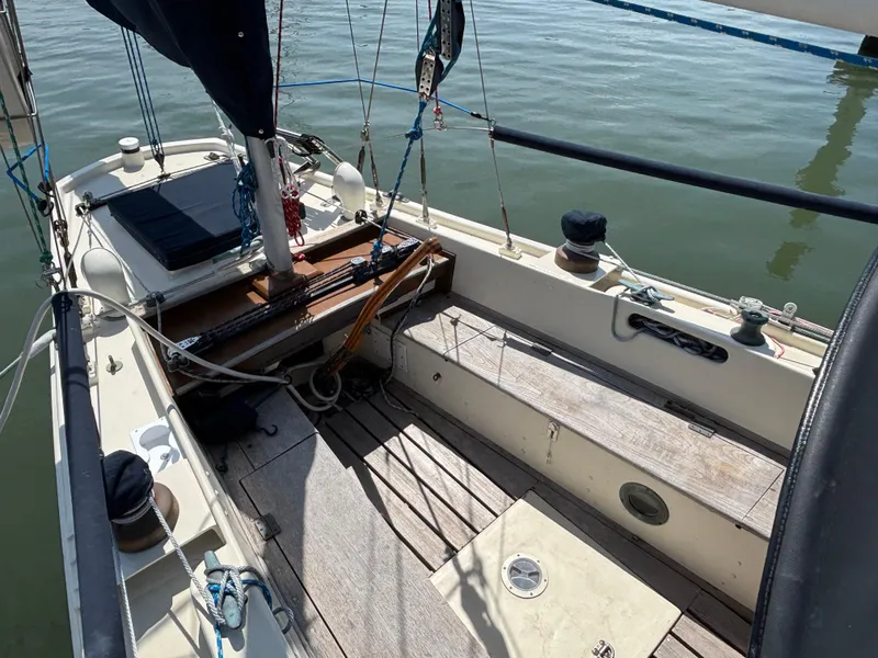Slide: The Image of 1955 Hinckley 36 Auxiliary Yawl sailboat cockpit with wooden deck and rigging. - 16
