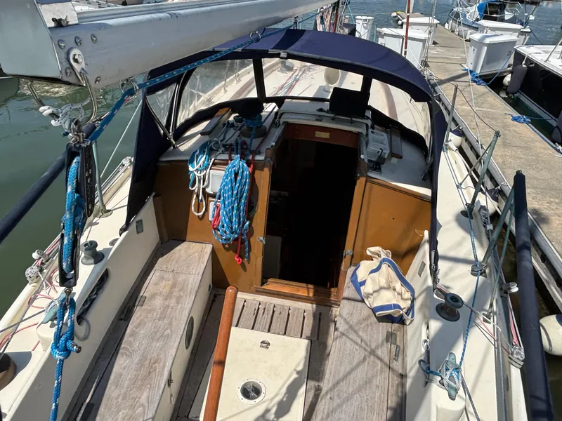 Slide: The Image of 1955 Hinckley 36 Auxiliary Yawl sailboat cockpit with ropes and wooden seating. - 27