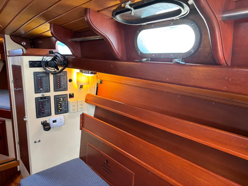 Slide: The Image of Interior of 1955 Hinckley 36 Auxiliary Yawl with wooden paneling and control panels. - 32