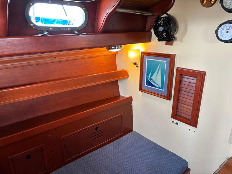 Slide: The Image of 1955 Hinckley 36 Auxiliary Yawl cabin interior with wooden finish and nautical decor. - 34