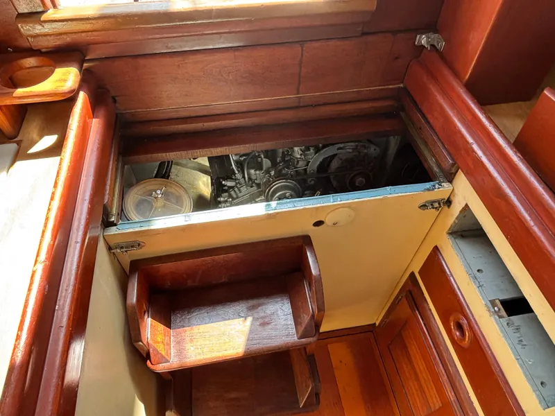 Slide: The Image of Interior view of a 1955 Hinckley 36 Auxiliary Yawl engine compartment with wooden finish. - 42