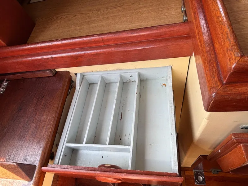 Slide: The Image of Empty wooden drawer inside a 1955 Hinckley 36 Auxiliary Yawl boat interior. - 46