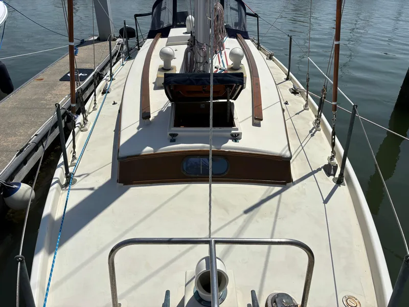 Slide: The Image of 1955 Hinckley 36 Auxiliary Yawl sailboat deck view at marina. - 7