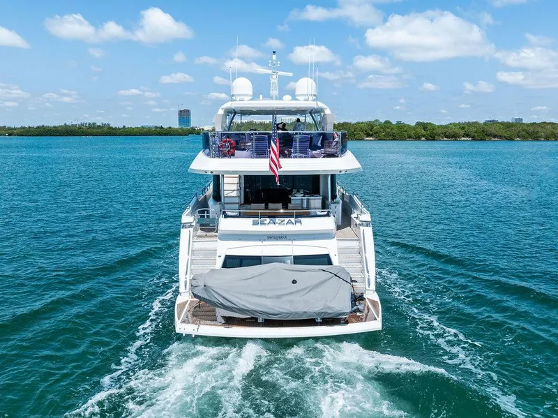 Slide: The Image of 2019 Sunseeker 86 Yacht cruising on blue waters under a clear sky. - 13