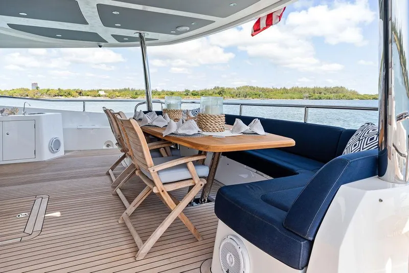 Slide: The Image of Luxurious 2019 Sunseeker 86 Yacht deck with elegant dining area and scenic water views. - 18