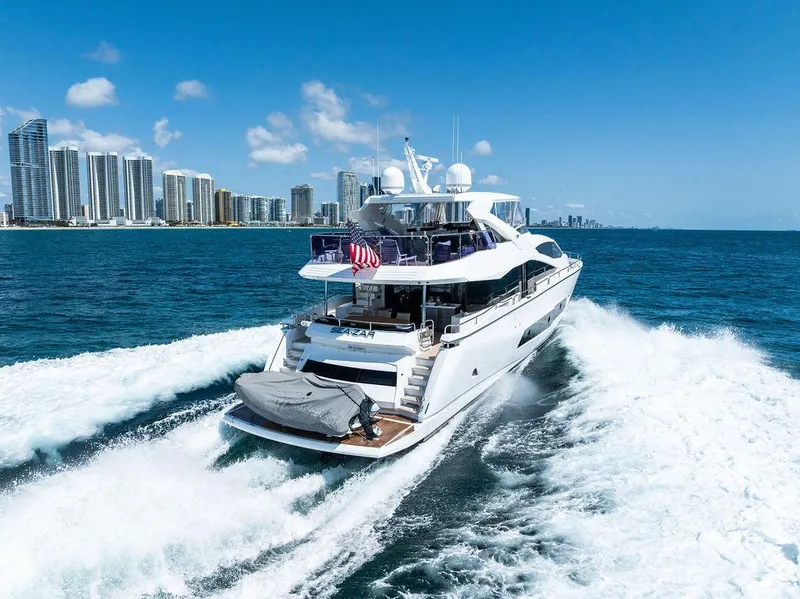 Slide: The Image of Luxurious 2019 Sunseeker 86 Yacht cruising on open water under a clear blue sky. - 2
