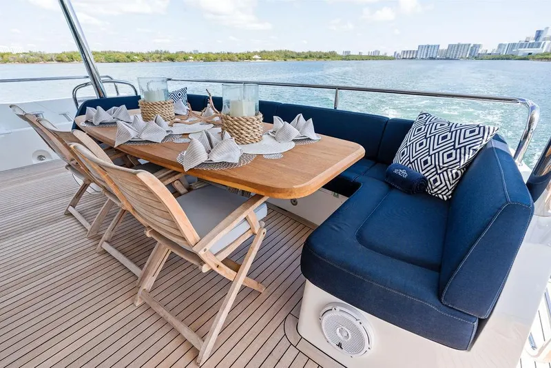 Slide: The Image of Outdoor dining area on 2019 Sunseeker 86 Yacht with elegant table setting and ocean view. - 23