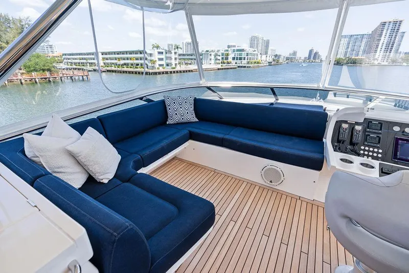 Slide: The Image of Luxurious 2019 Sunseeker 86 Yacht interior with blue seating and scenic waterfront view. - 27