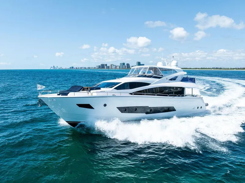 Slide: The Image of Luxurious 2019 Sunseeker 86 Yacht cruising near a city skyline on a sunny day. - 3