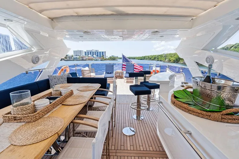 Slide: The Image of Luxurious 2019 Sunseeker 86 Yacht deck with elegant dining area and scenic waterfront view. - 30