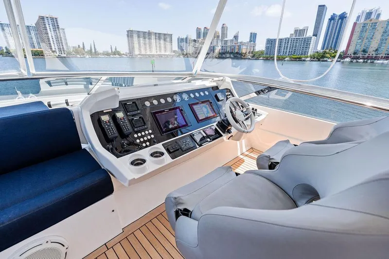 Slide: The Image of Helm of 2019 Sunseeker 86 Yacht with modern controls and waterfront city view. - 35