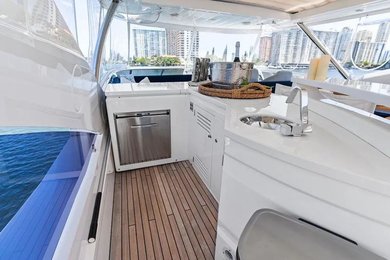 Slide: The Image of Luxurious 2019 Sunseeker 86 Yacht interior with modern kitchenette and scenic city views. - 39