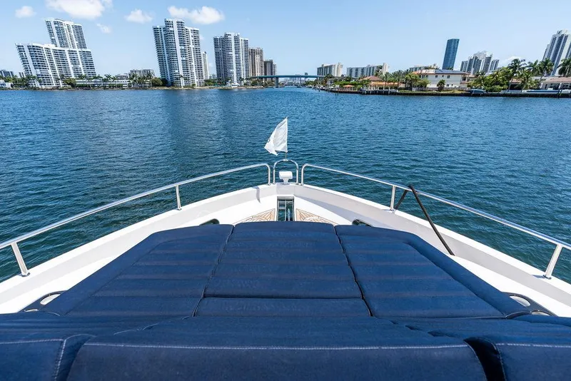 Slide: The Image of Sunseeker 86 Yacht 2019 cruising with city skyline in the background. - 44