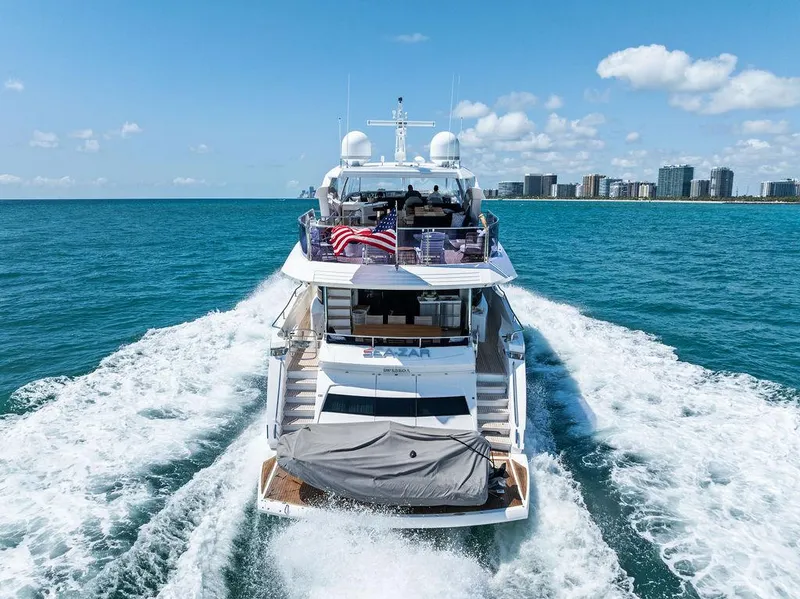 Slide: The Image of 2019 Sunseeker 86 Yacht cruising on blue ocean near city skyline. - 9