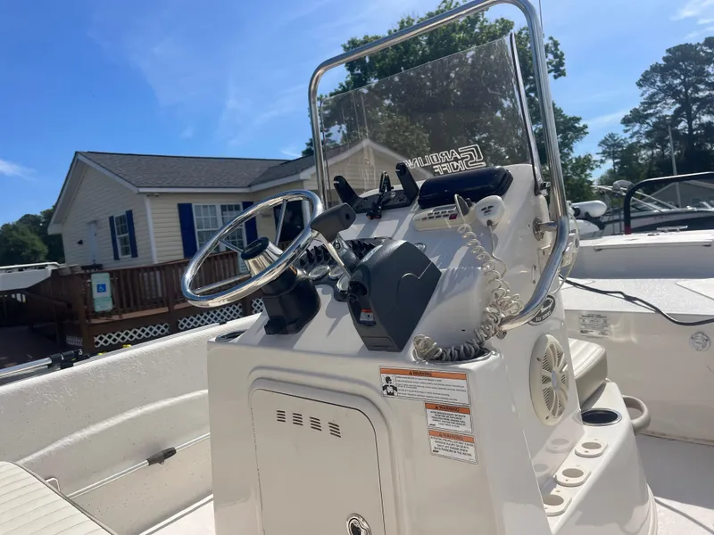 Slide: The Image of 2017 Carolina Skiff 178 DLV boat console with steering wheel and controls. - 10