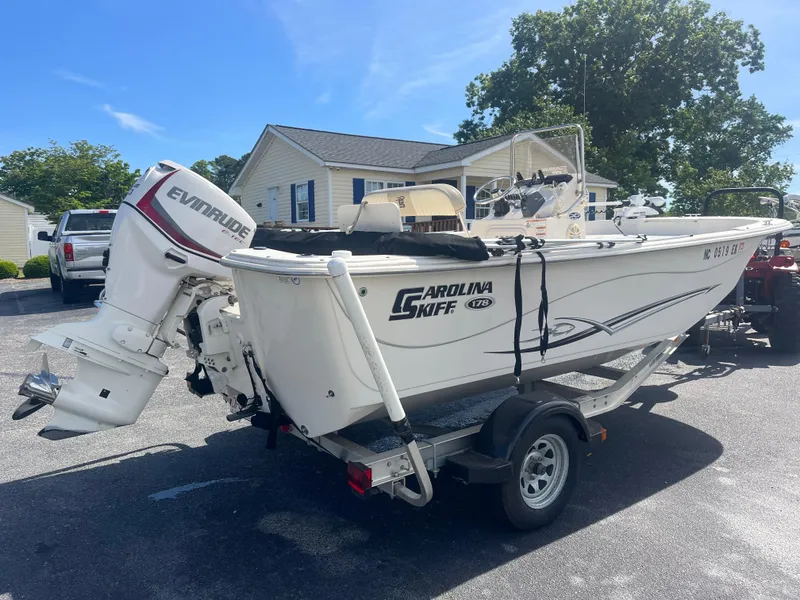 Slide: The Image of 2017 Carolina Skiff 178 DLV boat on trailer with Evinrude outboard motor. - 2