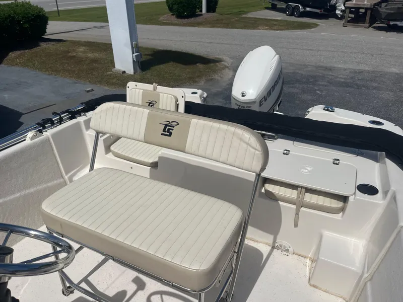 Slide: The Image of 2017 Carolina Skiff 178 DLV boat interior with seating and Evinrude outboard motor. - 7