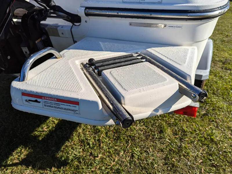 Slide: The Image of 2024 Bayliner Trophy T18 swim platform with foldable ladder on grass. - 4