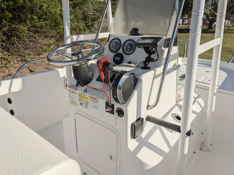 Slide: The Image of 2024 Bayliner Trophy T18 boat console with steering wheel and controls. - 5