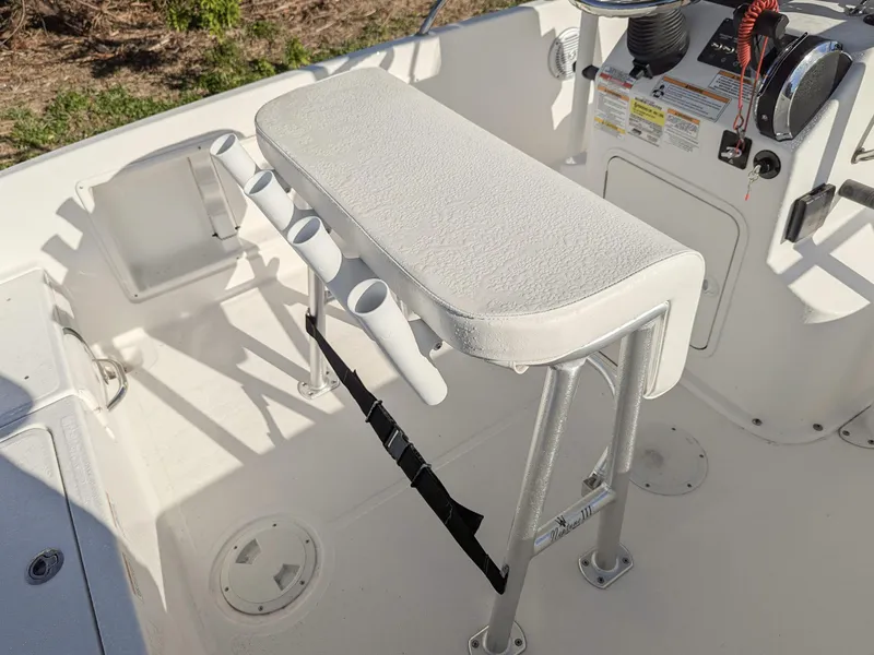 Slide: The Image of 2024 Bayliner Trophy T18 boat interior with rod holders and cushioned seating. - 6