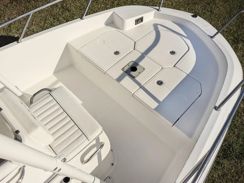 Slide: The Image of 2024 Bayliner Trophy T18 boat deck with seating and storage compartments. - 7
