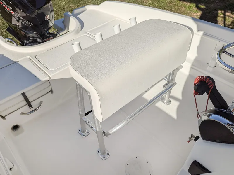 Slide: The Image of 2024 Bayliner Trophy T18 boat interior with white seating and control panel. - 8