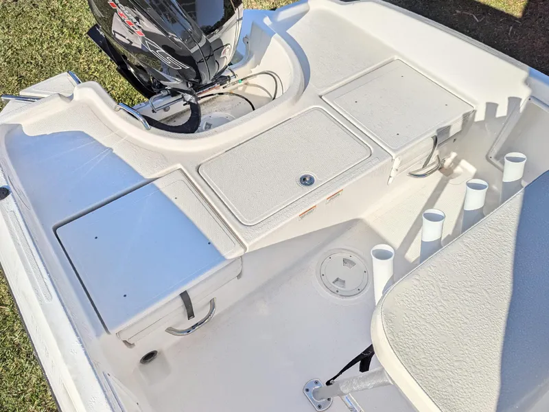Slide: The Image of 2024 Bayliner Trophy T18 boat deck with storage compartments and motor. - 9