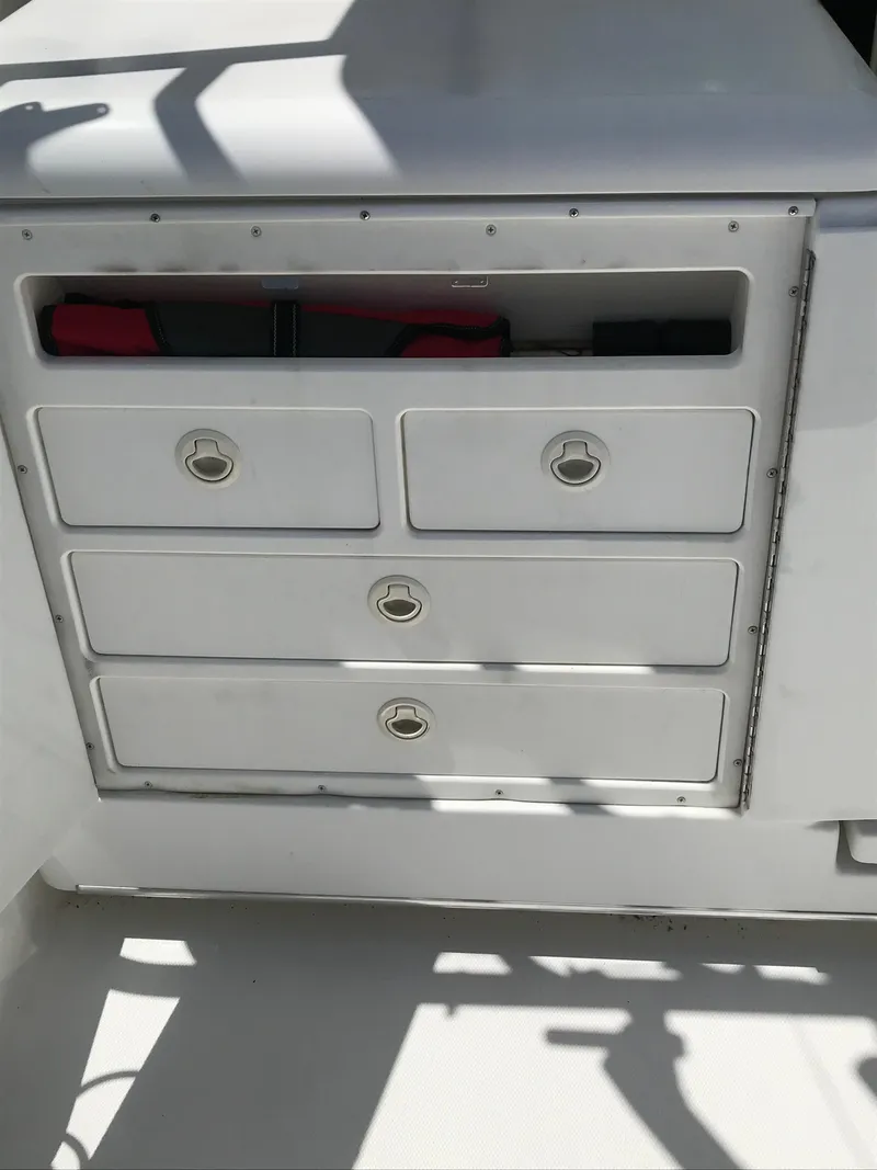 Slide: The Image of 2005 Rampage 30' Express Sportfish boat storage drawers in white, featuring four compartments. - 12