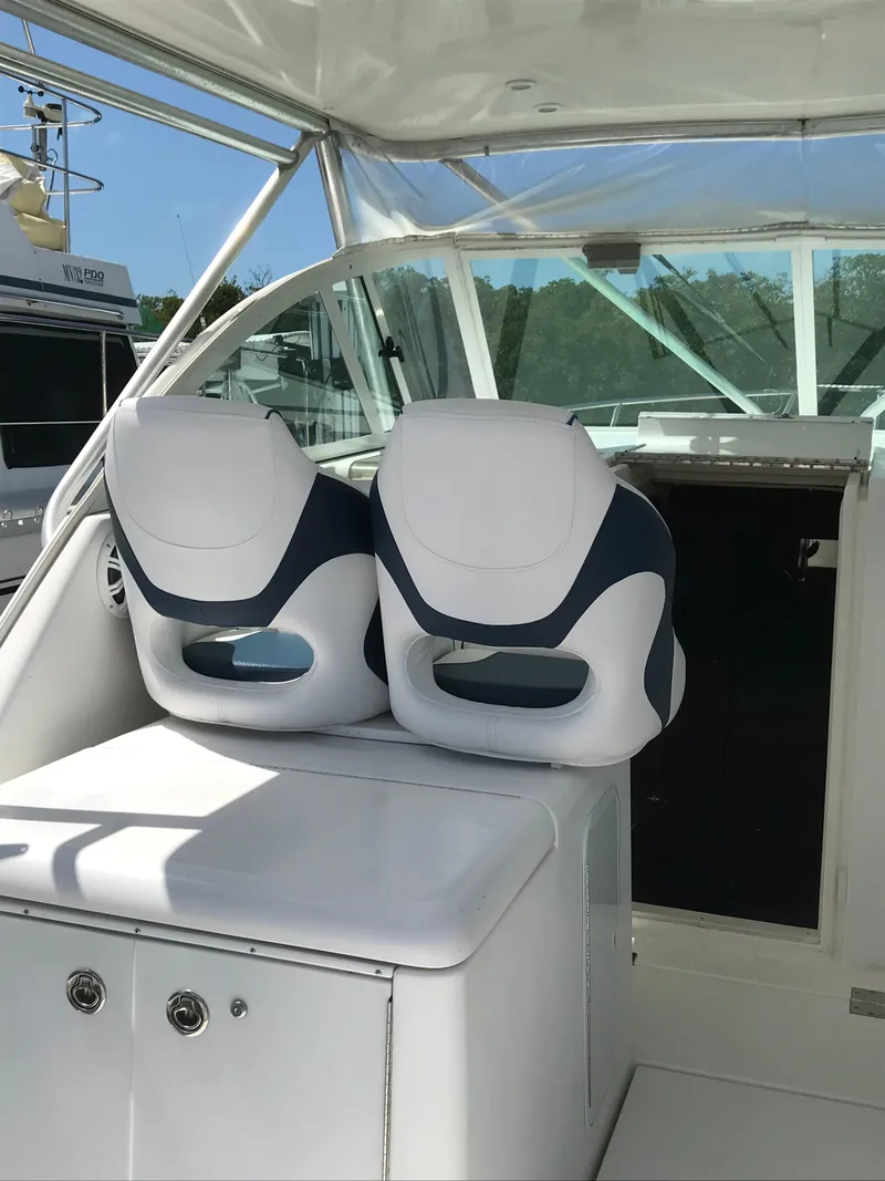 Slide: The Image of 2005 Rampage 30' Express Sportfish boat interior with dual white seats. - 14