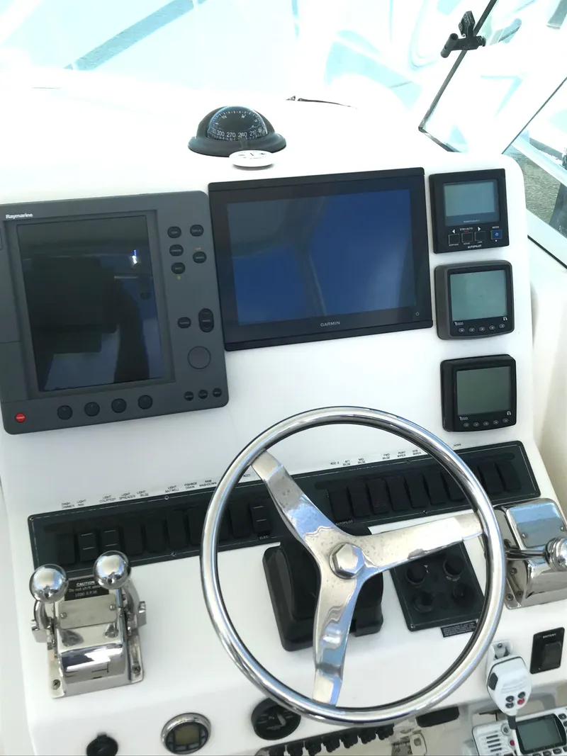 Slide: The Image of Control panel of a 2005 Rampage 30' Express Sportfish boat with navigation equipment. - 15