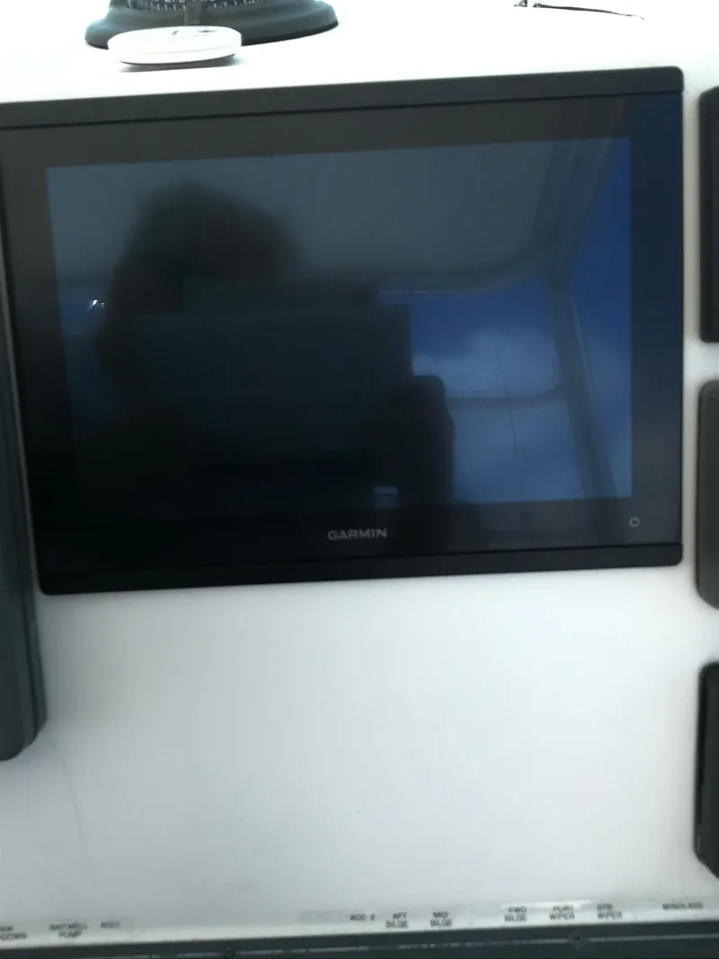 Slide: The Image of 2005 Rampage 30' Express Sportfish with Garmin display on dashboard. - 17